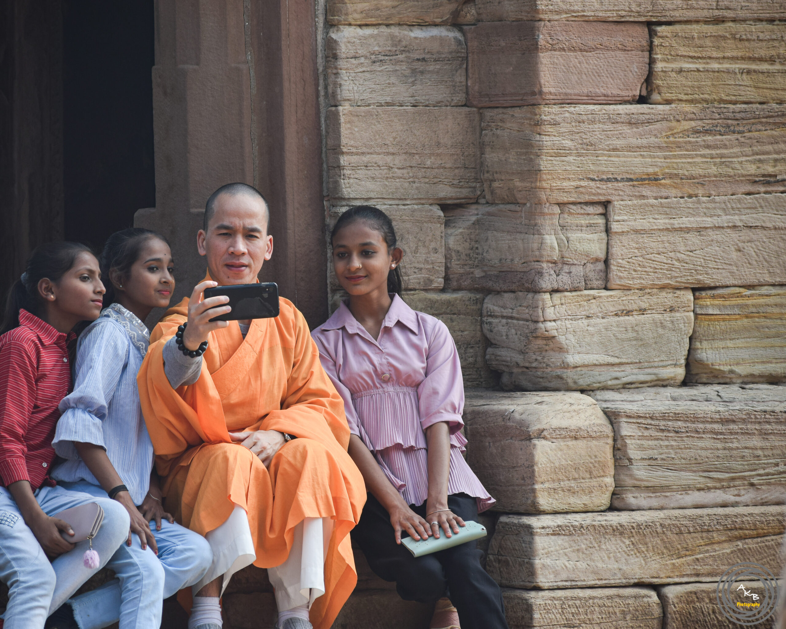 A Buddhist monk taking a photo with the kids